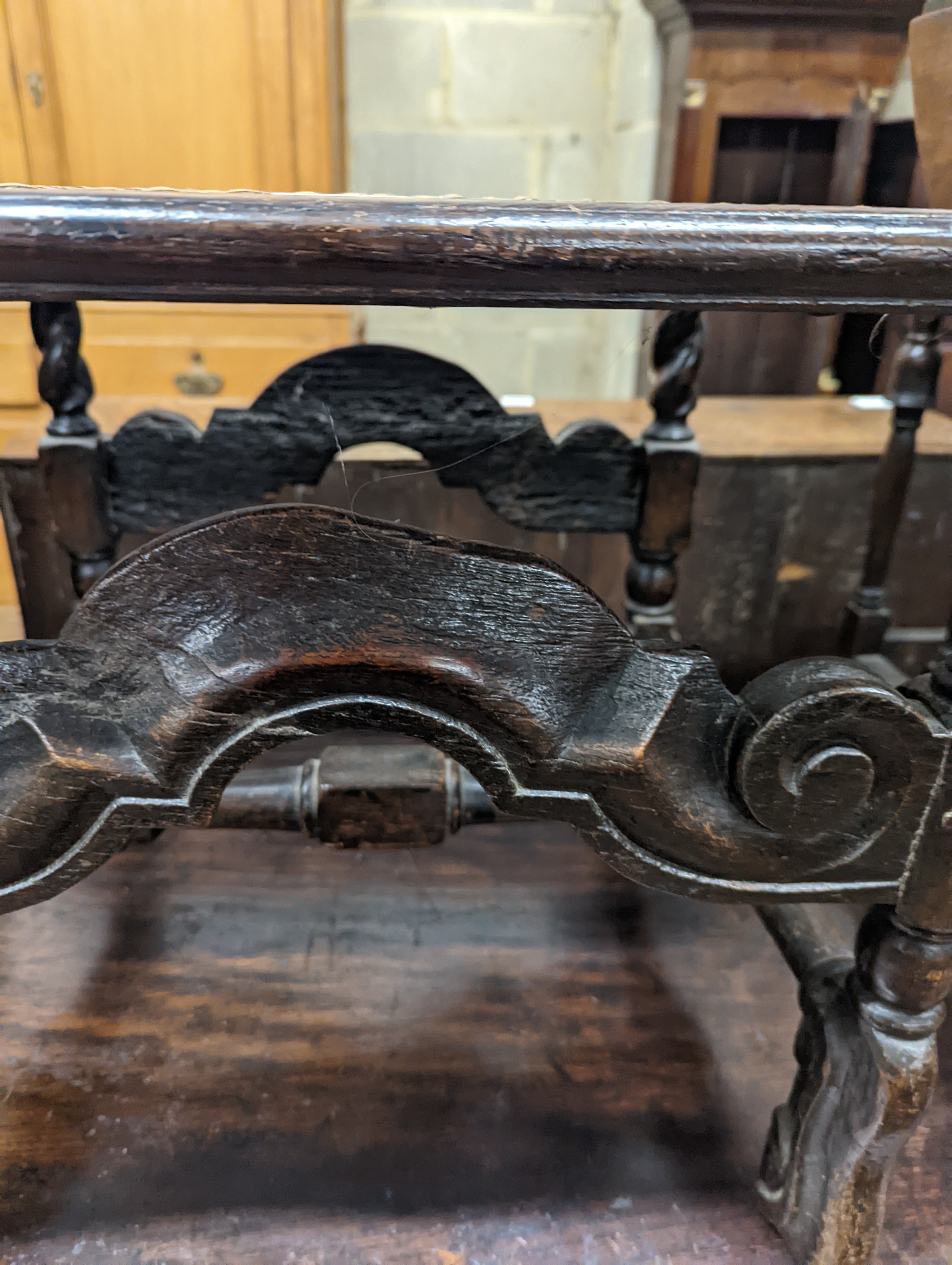 A 17th century style carved oak stool, with caned seat and H stretcher, width 47cm, depth 46cm, height 42cm